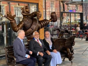 Photo of the bronze Wallace and Gromit bench with Nick Park anf other Preston leaders. 