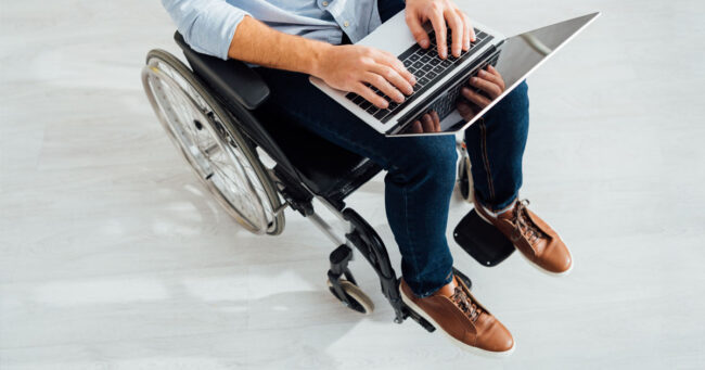 Man in wheelchair using his laptop