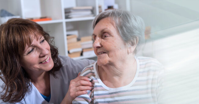 Woman is sat at home with carer