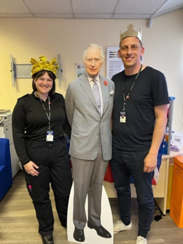 DENW Associates standing with cardboard cut out of King Charles