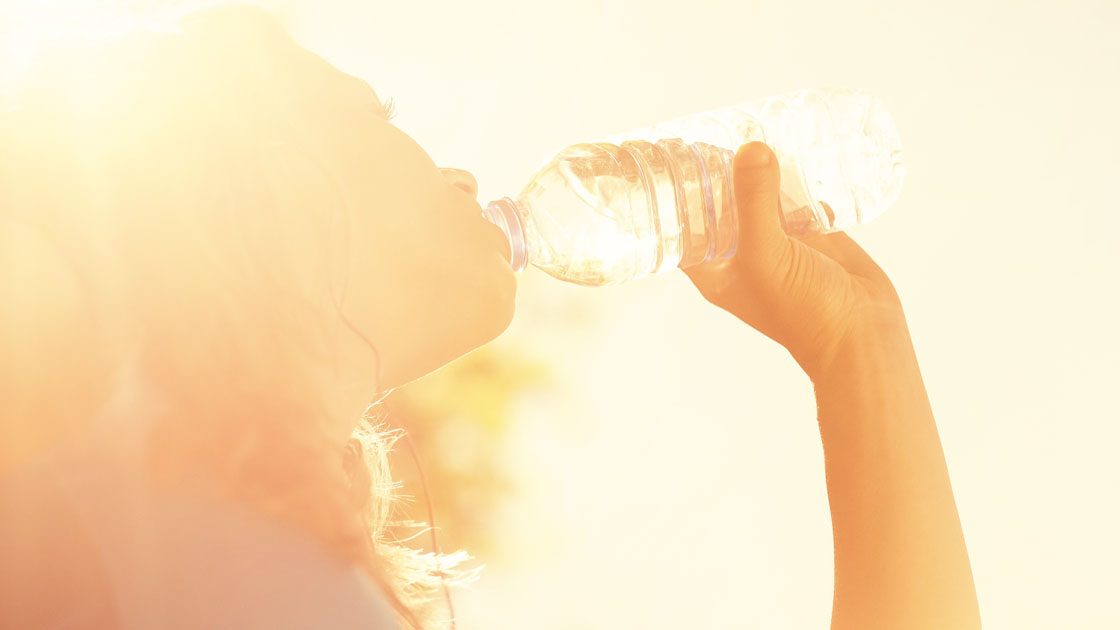 Woman drinking from bottle of water Woman drinking from bottle of water