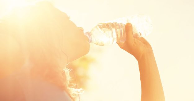 Woman drinking from bottle of water Woman drinking from bottle of water