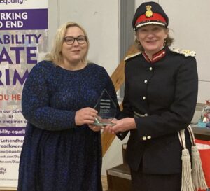 Photograph of Sandra and Amanda Parker, DL, Lord-Lieutenant for the County of Lancashire - with them both holding the Lesley Finley Award trophy.