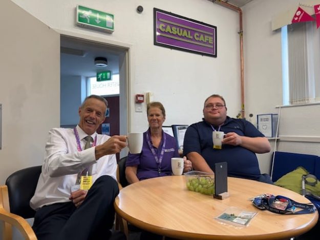County Councillor Graham Dalton, LCC Cabinet Photo of CC Graham on the left, Mel Close in the middle and Daniel Duckworth Denw Trustee on the right. All in the Casual Cafe with a pretty sign above their heads, all holding their brews up smiling at the camera