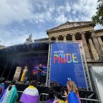 Wide shot of the Preston Pride stage, with the background of the Harris looming over bright and bold.