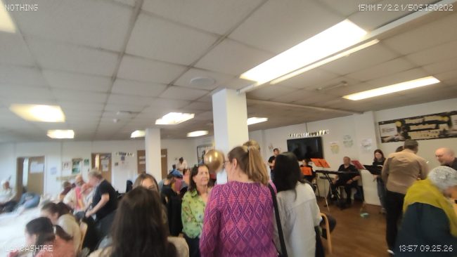 Wide shot of a busy room, celebrating a Midafternoon Gathering @ DENW's 30th